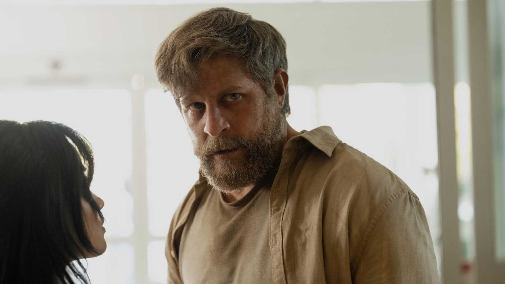 Joe Tippett as Tim looking serious in Monarch Legacy of Monsters