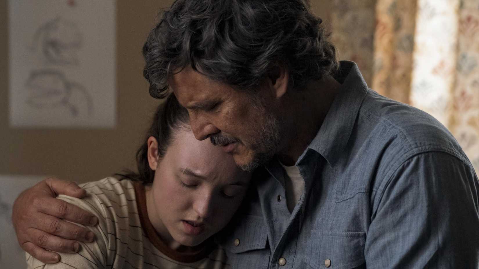 Joel (Pedro Pascal) hugging and comforting Ellie (Bella Ramsey) in The Last of Us
