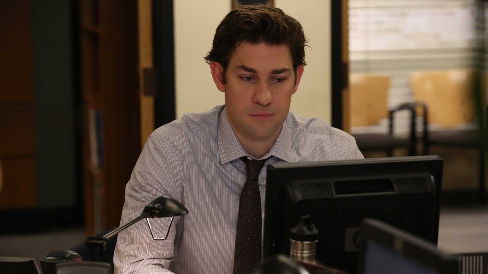 John Krasinski as Jim Halpert looks at his computer. 