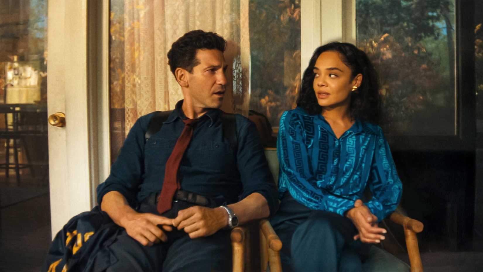 Jon Bernthal and Tessa Thomson sit next to each other and look at each other in 'His & Hers'