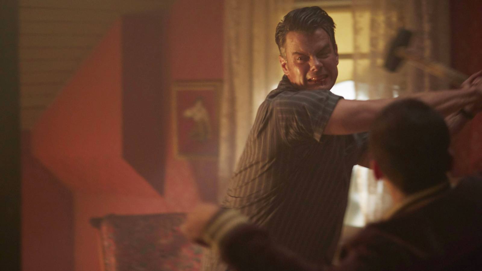 Josh Duhamel swinging an axe in an episode of 11-22-63