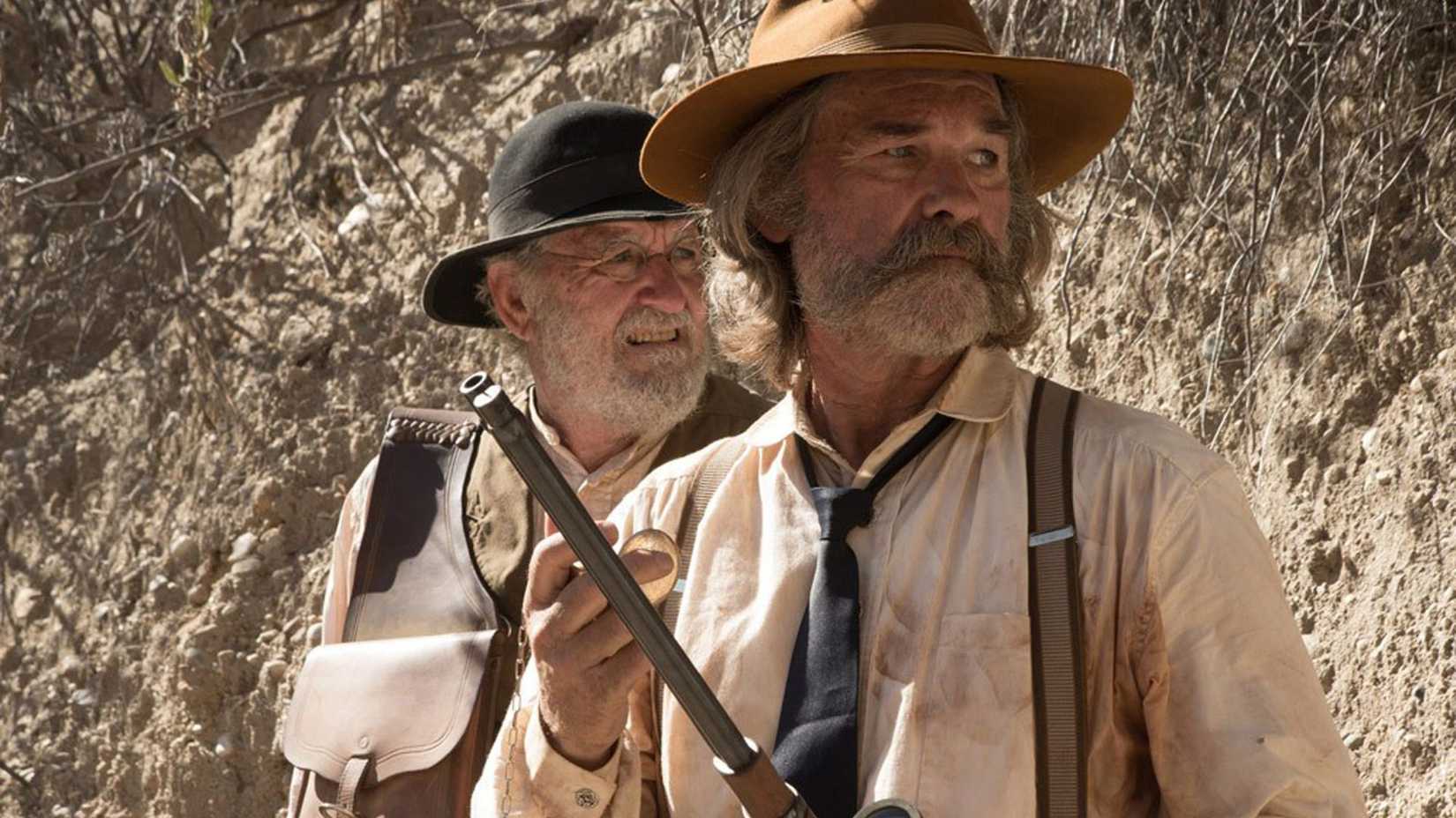 Kurt Russell as Sheriff Franklin Hun standing in front of Richard Jenkins as Deputy Chicory in Bone Tomahawk