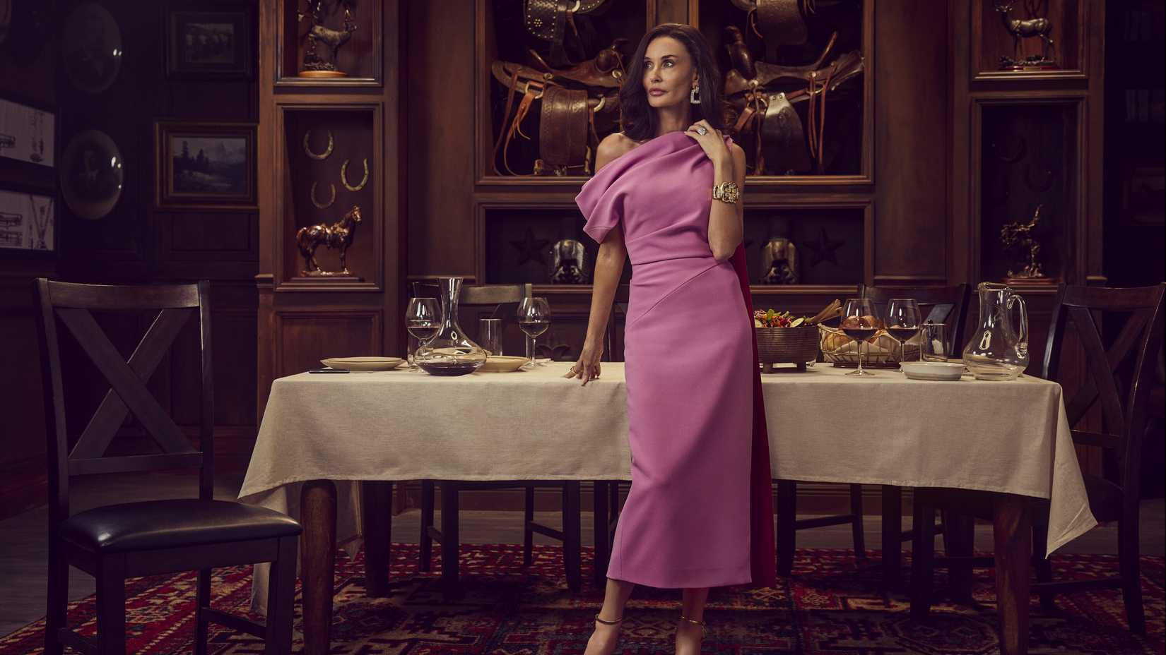 Cami Miller (Demi Moore) standing in front of a fancy table wearing an elegant pink dress in Landman season 2