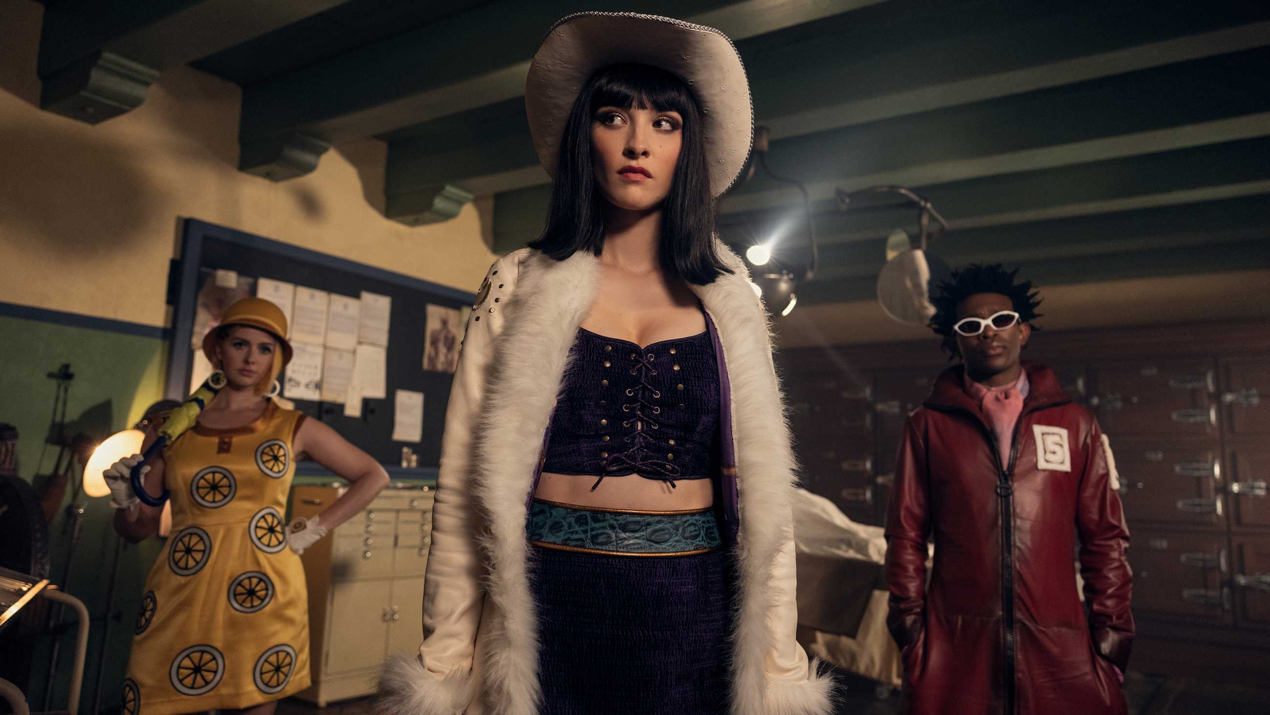 Lera Abova's Nico Robin looking suspiciously with Camrus Johnson's Mr. 5 and Jazzara Jaslyn's Miss Valentine behind her in One Piece season 2