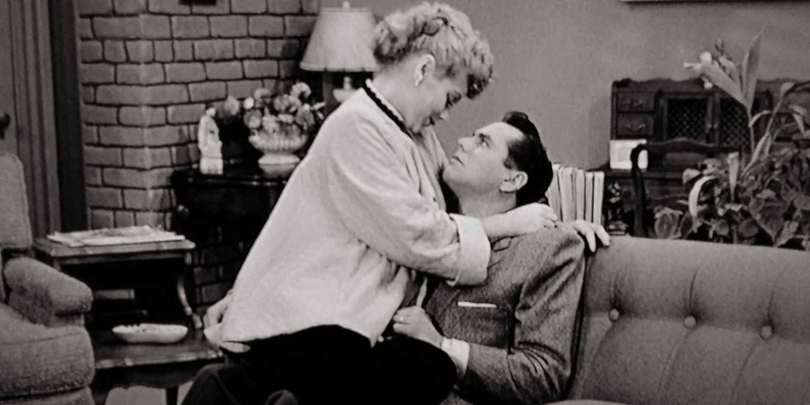 Lucy sits with Ricky in I Love Lucy