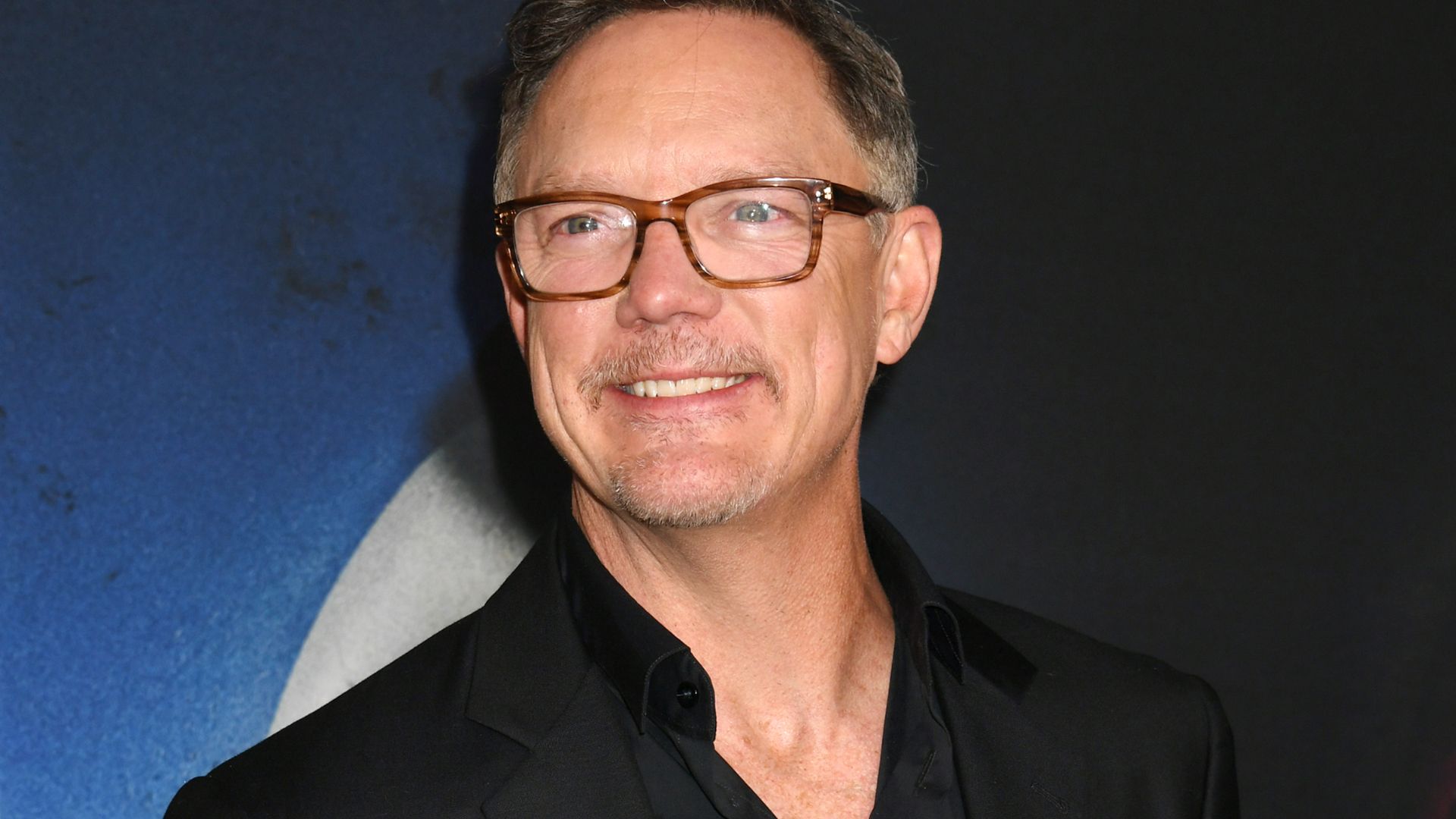 Matthew Lillard smiling on a red carpet for Five Nights at Freddy's 2