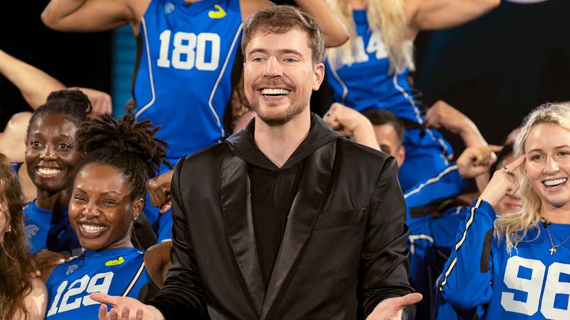 mrbeast standing in front of a variety of contestants in beast games season 2