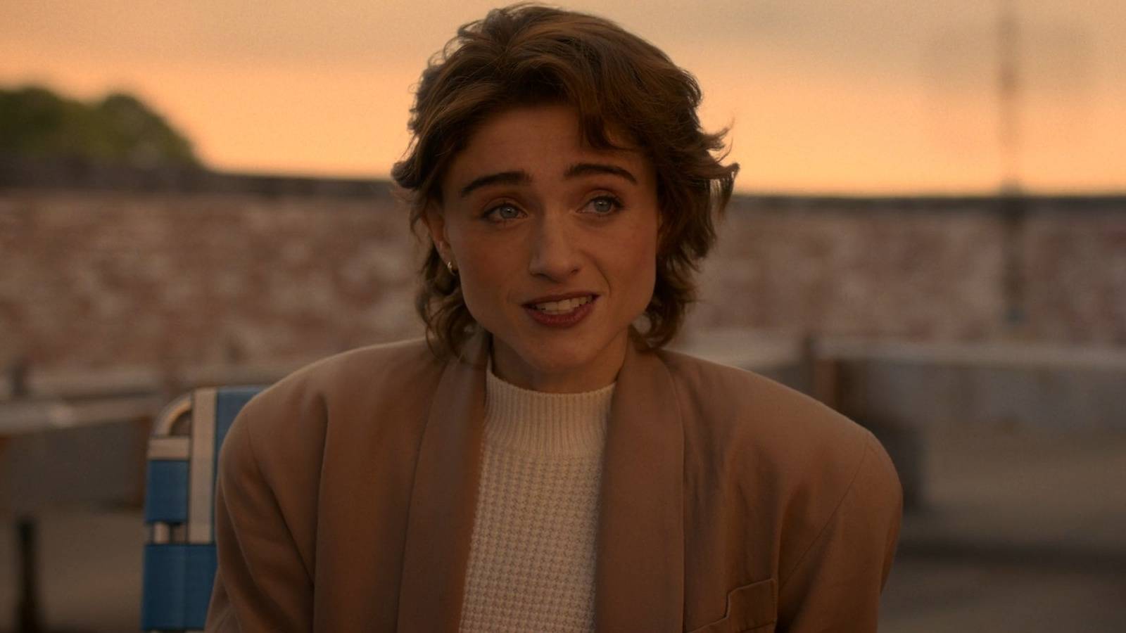 Nancy Wheeler (Natalia Dyer) sitting on the roof and talking in the Stranger Things series finale