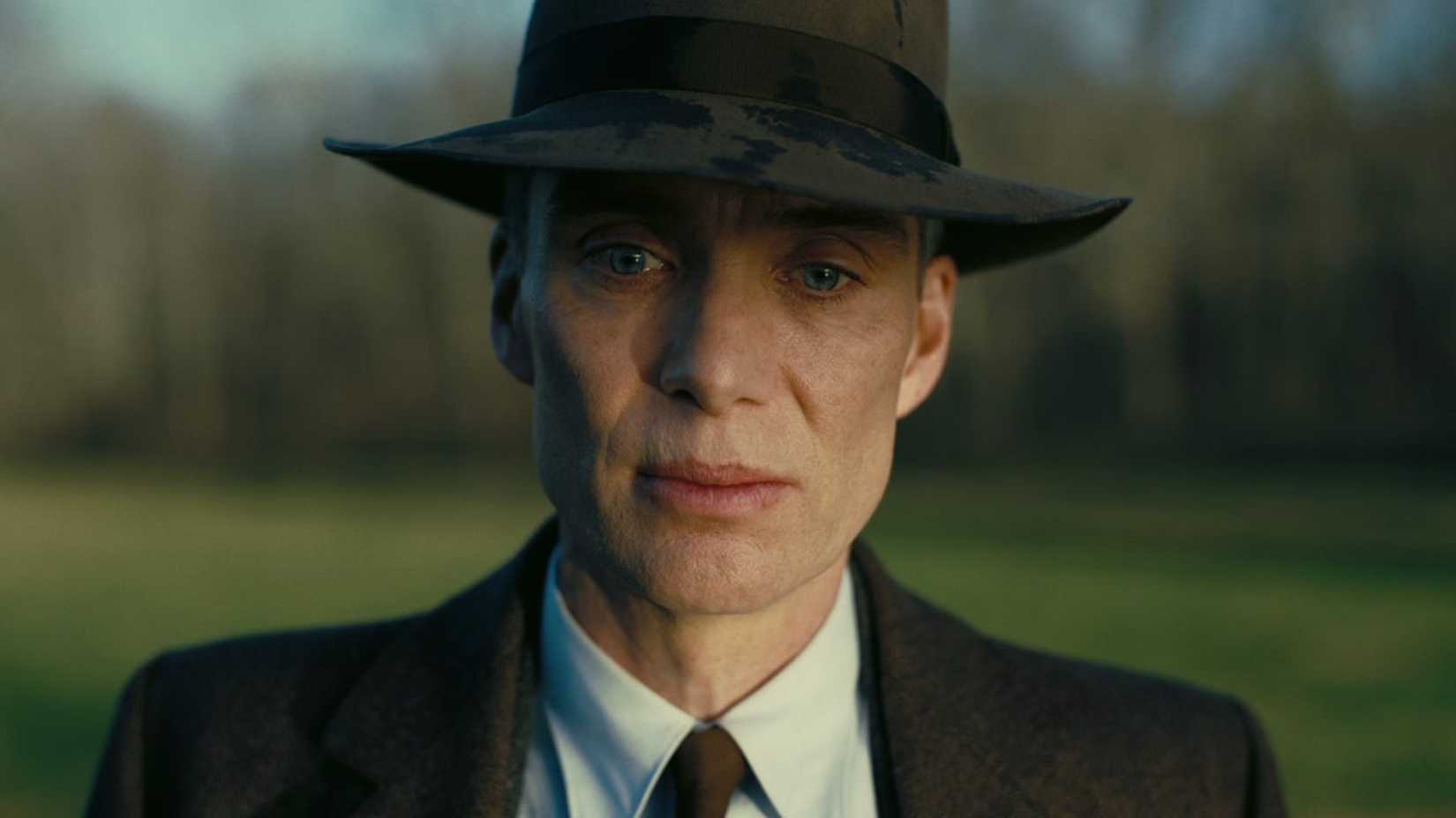J. Robert Oppenheimer looks down in despair in Oppenheimer