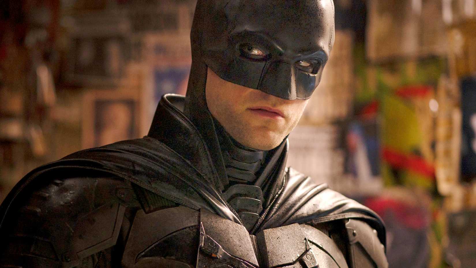 Robert Pattinson as Batman in The Batman looking off-screen