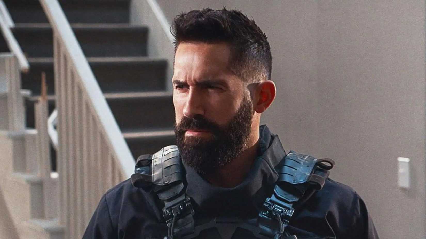Scott Adkins looks on with a full beard