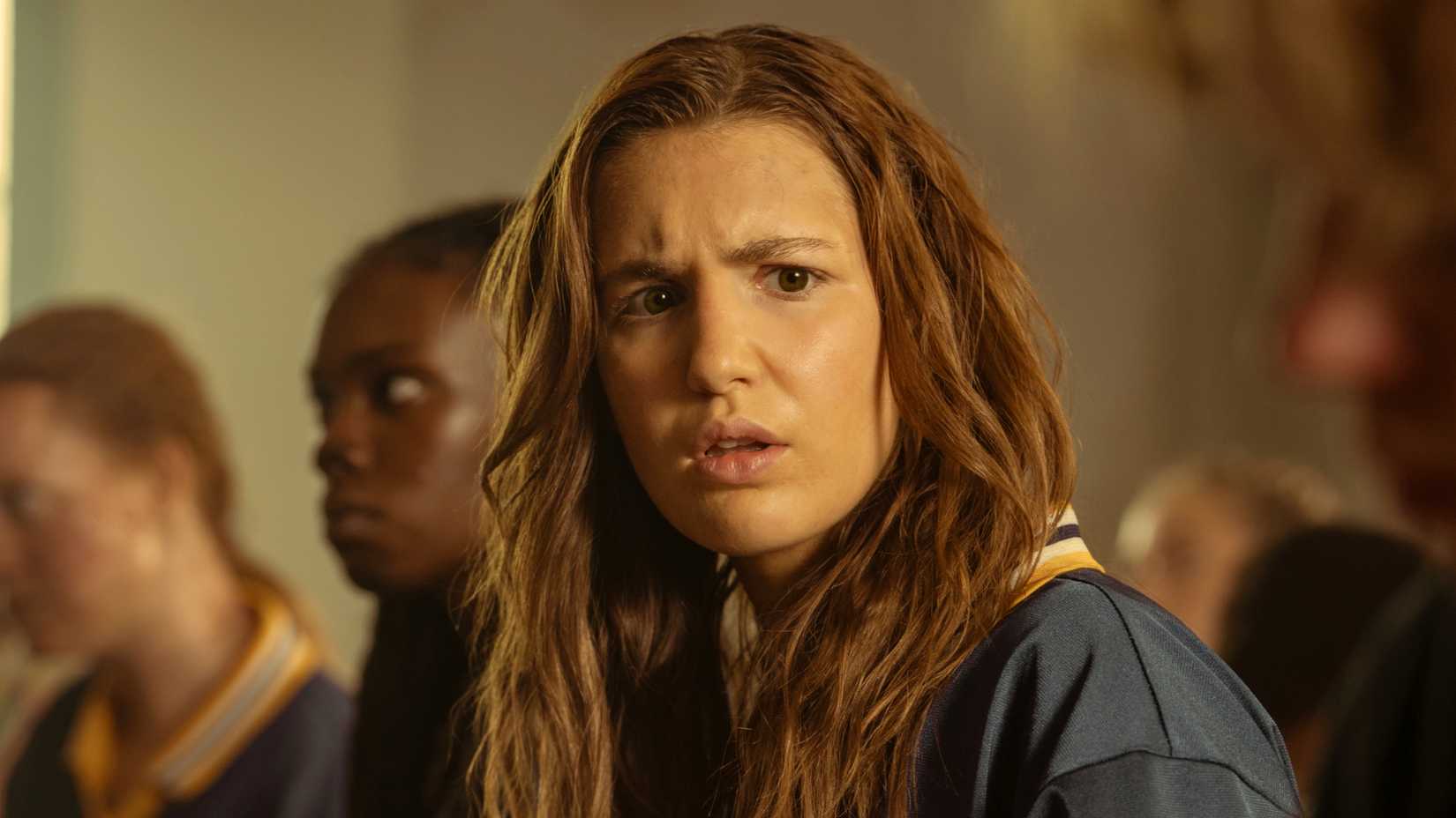 Sophie Nelisse as teen Shauna in her uniform in a dream in Yellowjackets season 3