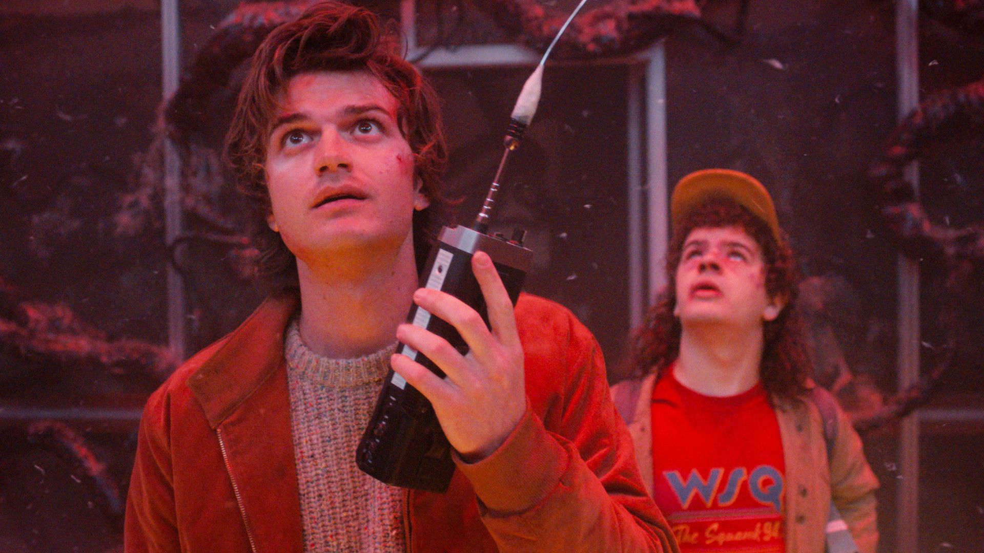 Steve and Dustin in Stranger Things season 5. Steve's holding a walkie talkie while they're in the Upside Down