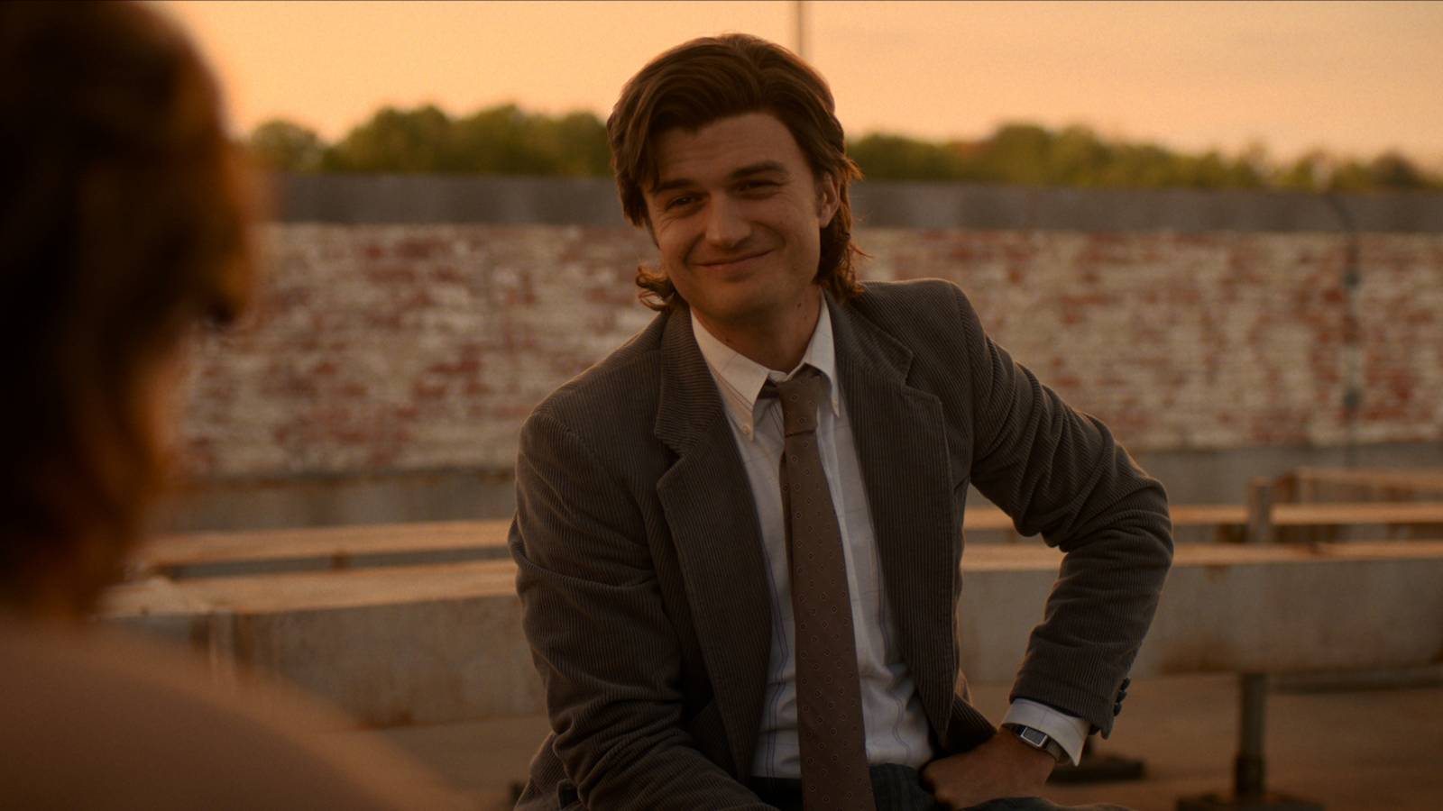 Steve in a suit smiling at Nancy in Stranger Things season 5 episode 8