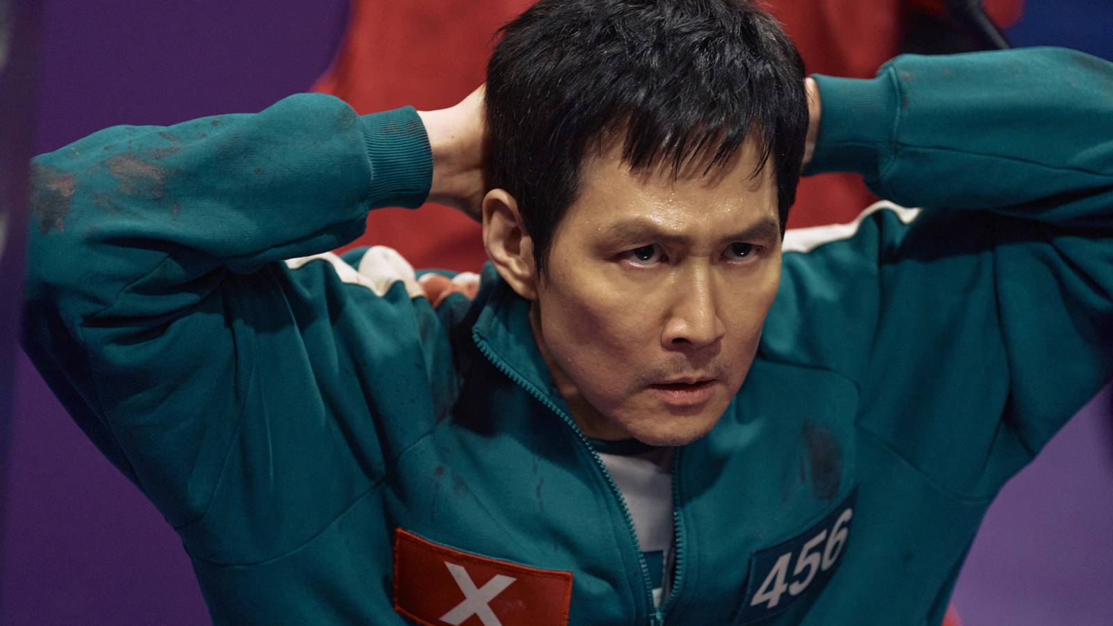 Seong Gi-hun (Lee Jung-jae) with his hands on his head in Squid Game season 2