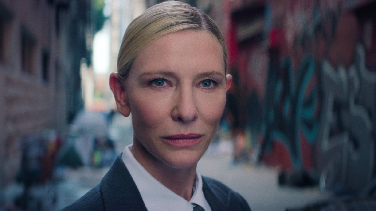 Cate Blanchett as the American Recruiter standing in an alley in the Squid Game series finale
