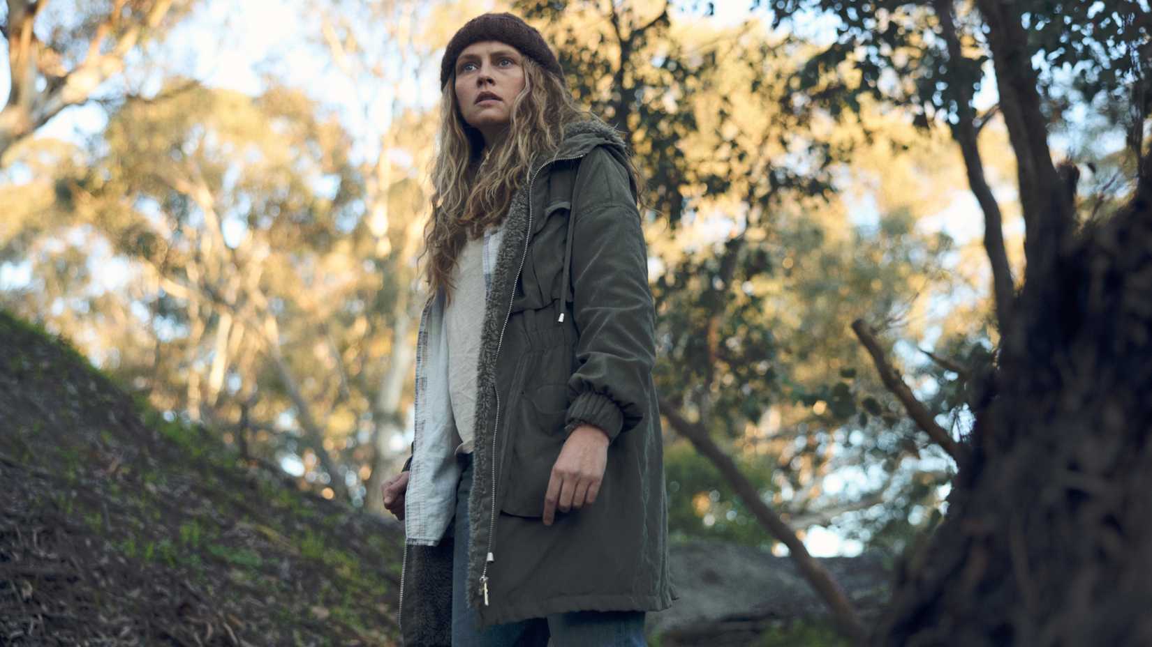 Teresa Palmer as Freya Heywood looking scared in the woods in The Clearing