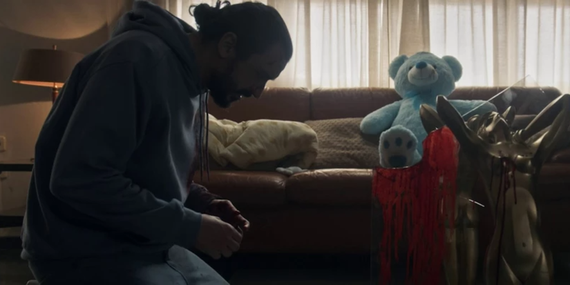 Jesus kneeling before bloody glass in The Coffee Table