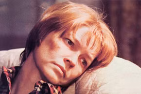 Ellen Burstyn as Chris MacNeil looking exhausted on the couch in The Exorcist.