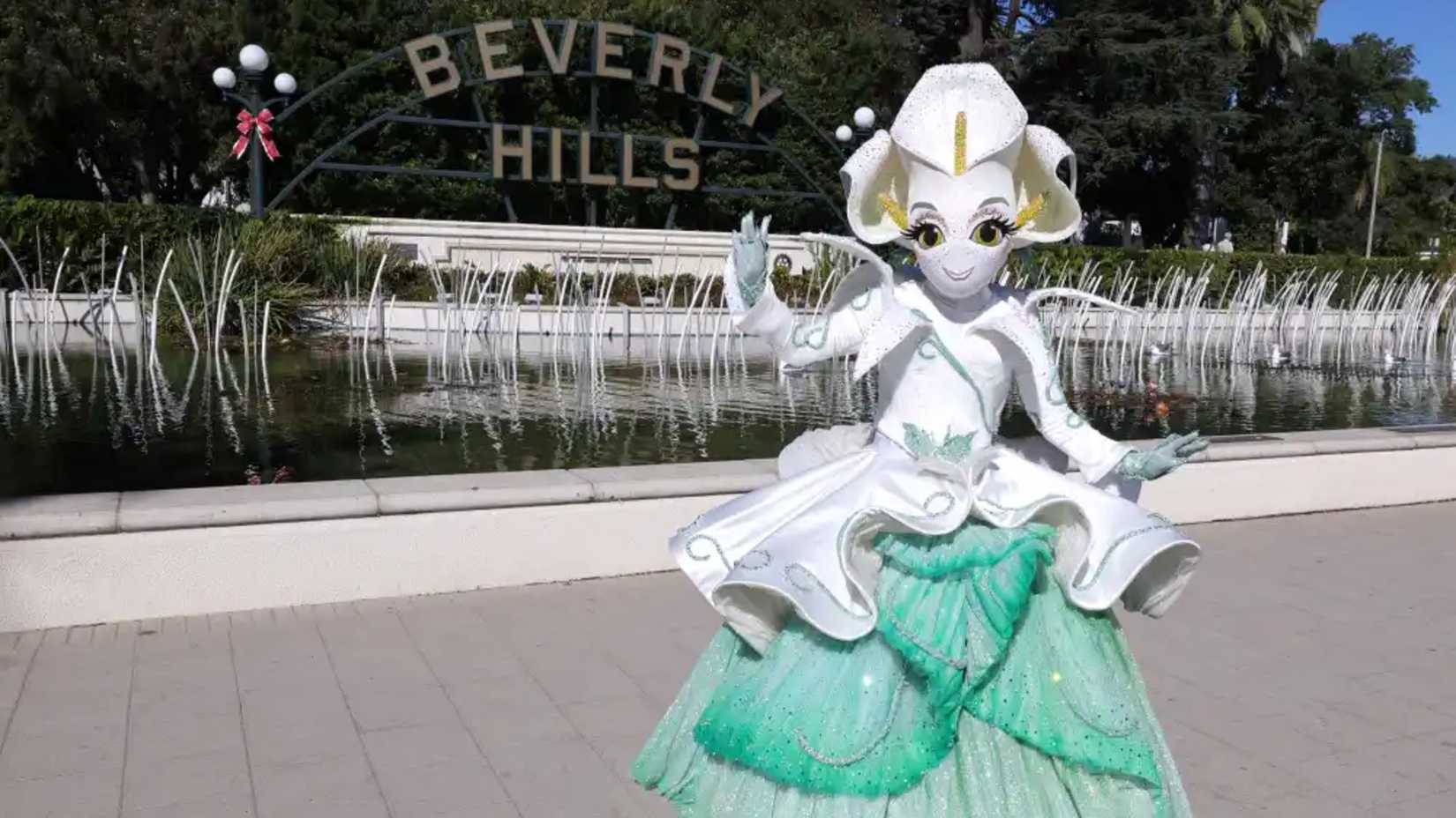 The Masked Singer Season 14 Contestant Calla Lily Standing In Front of the Beverly Hills Sign