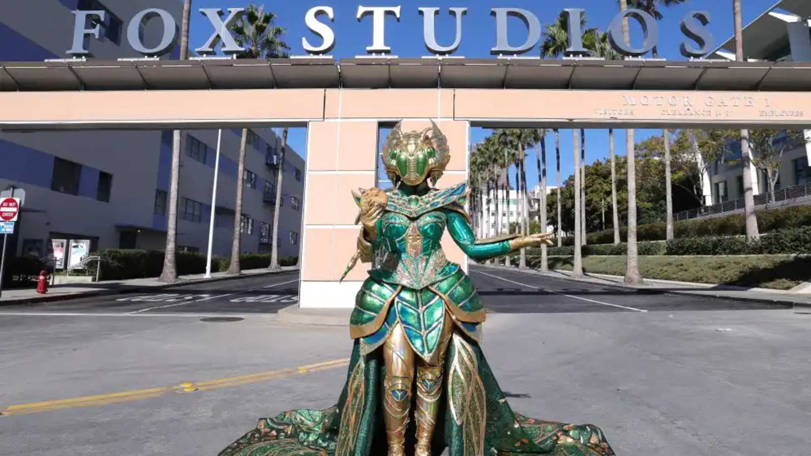 The Masked Singer Season 14 Contestant Scarab Standing In Front of the FOX Studios With a Cookie