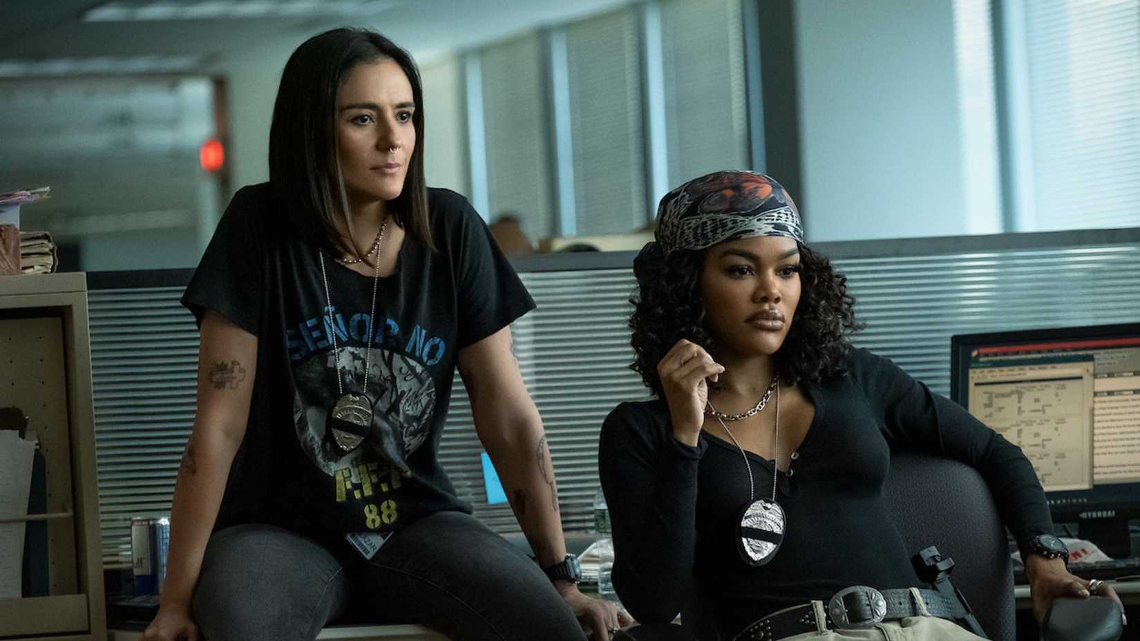 Salazar and Baptiste look on in the office in The Rip