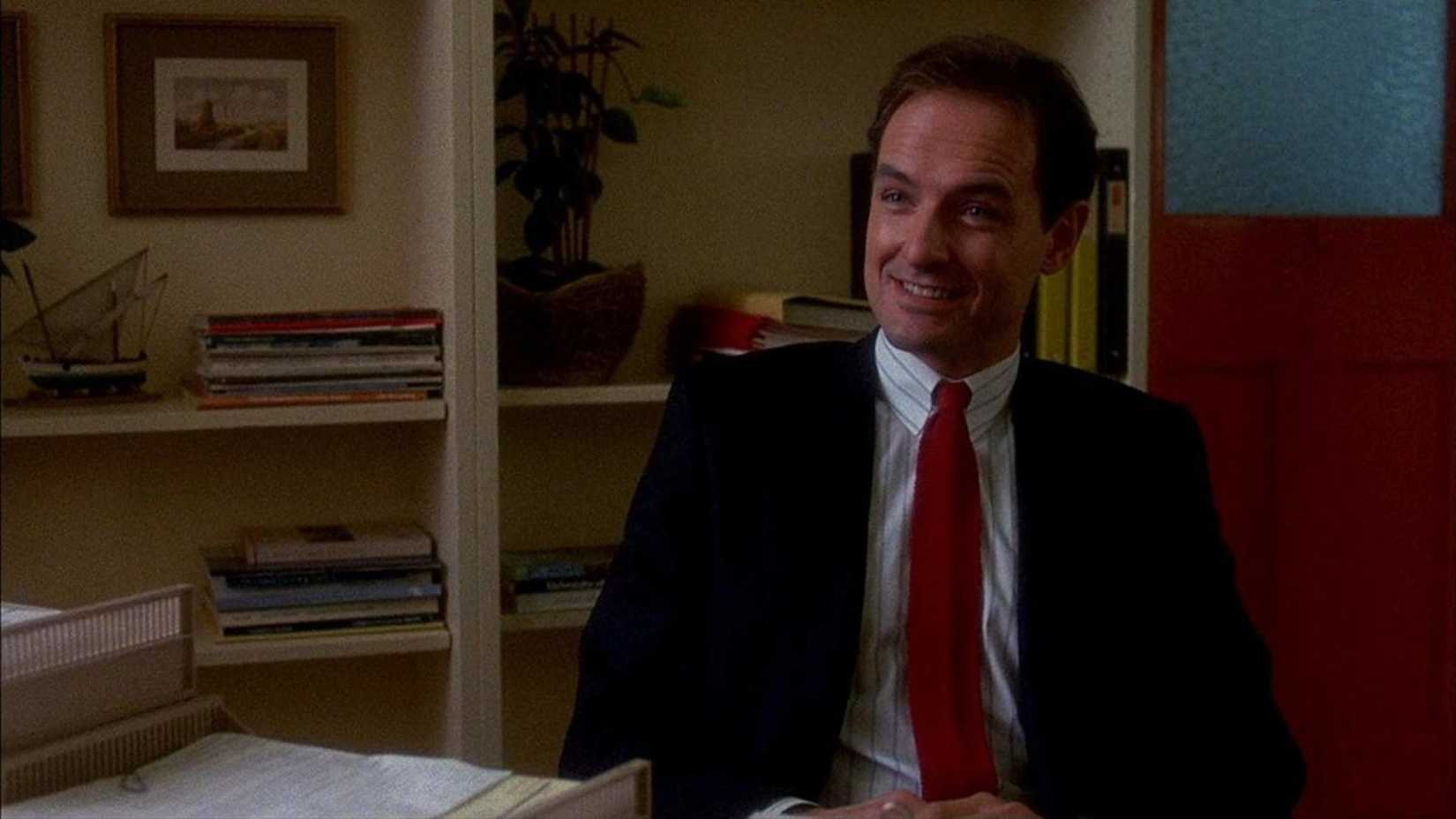 Terry O'Quinn smiles in a job interview in The Stepfather