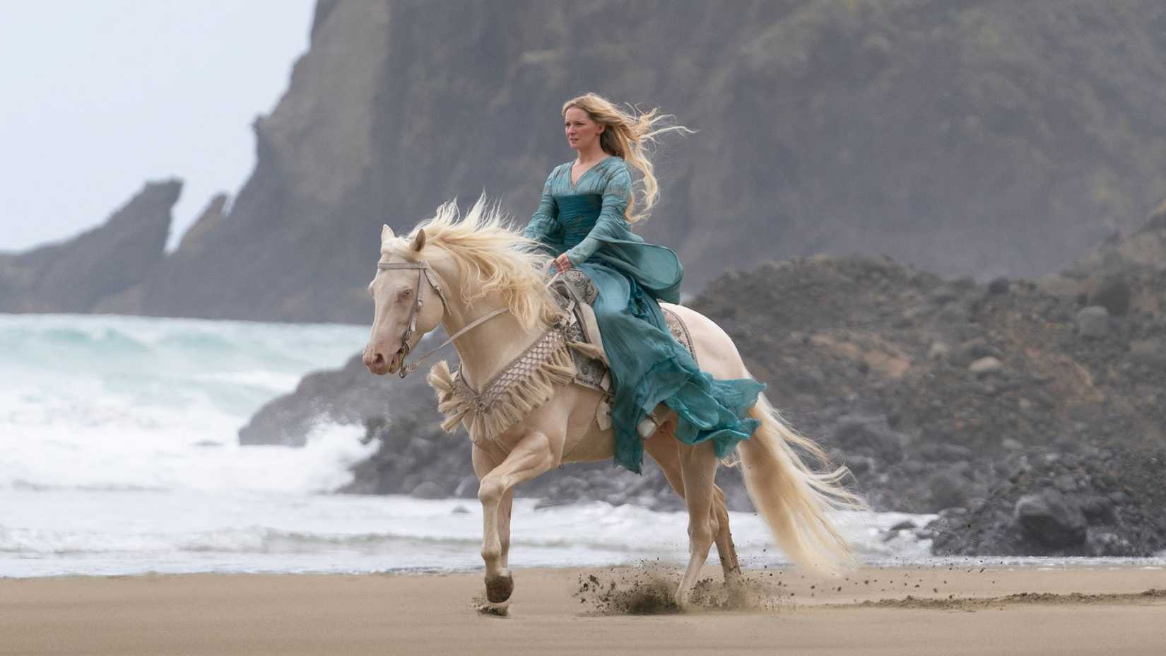 Galadriel cavalgando em uma praia