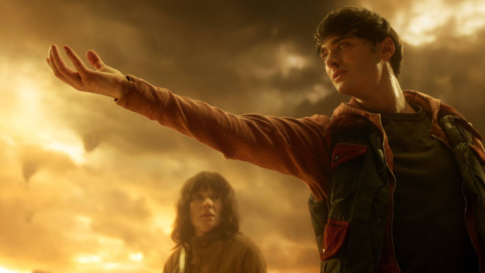 Will with his hand extended as Joyce watches in the Stranger Things series finale