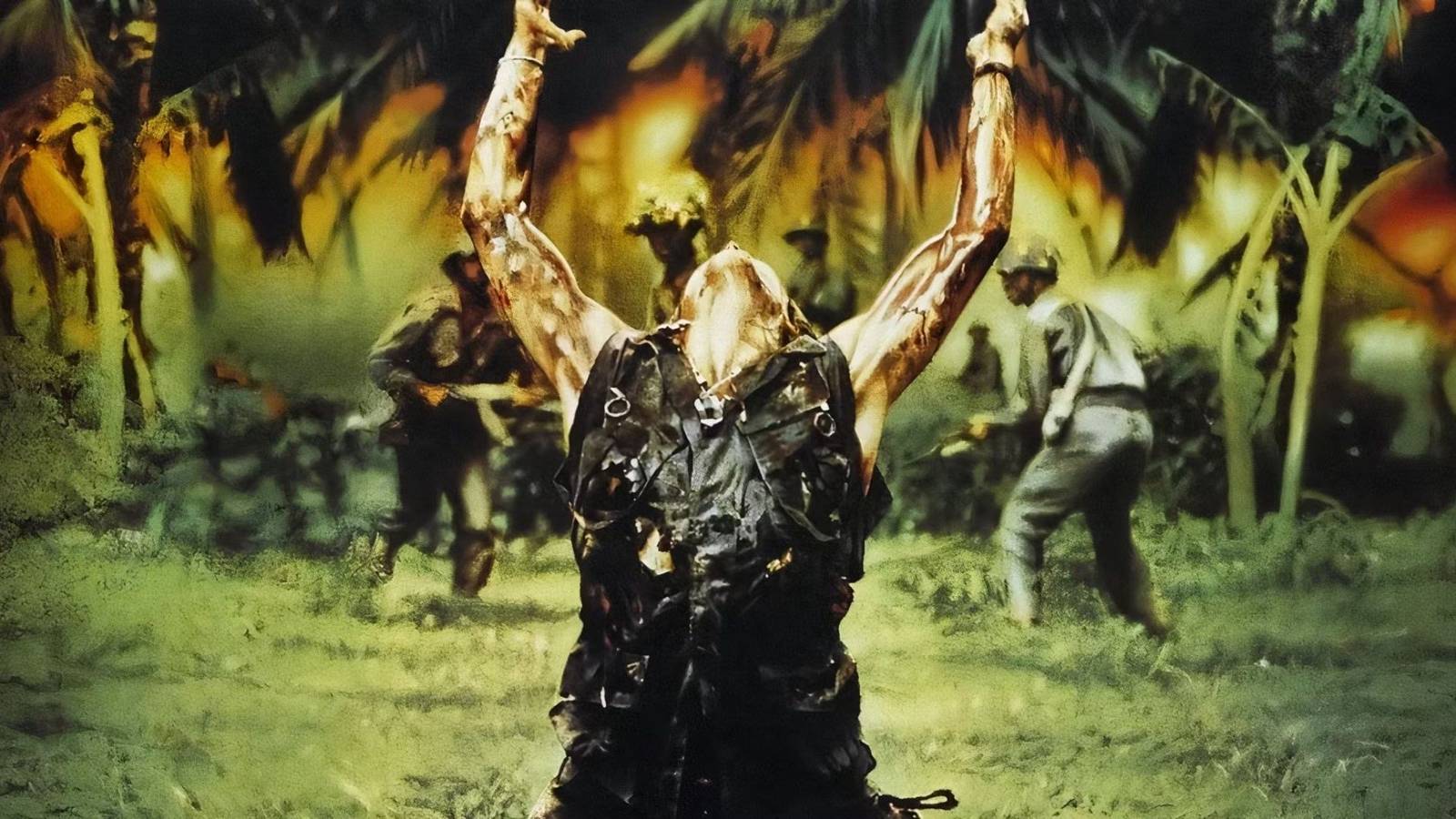 Willem Dafoe throws his arms up as Elias in Platoon