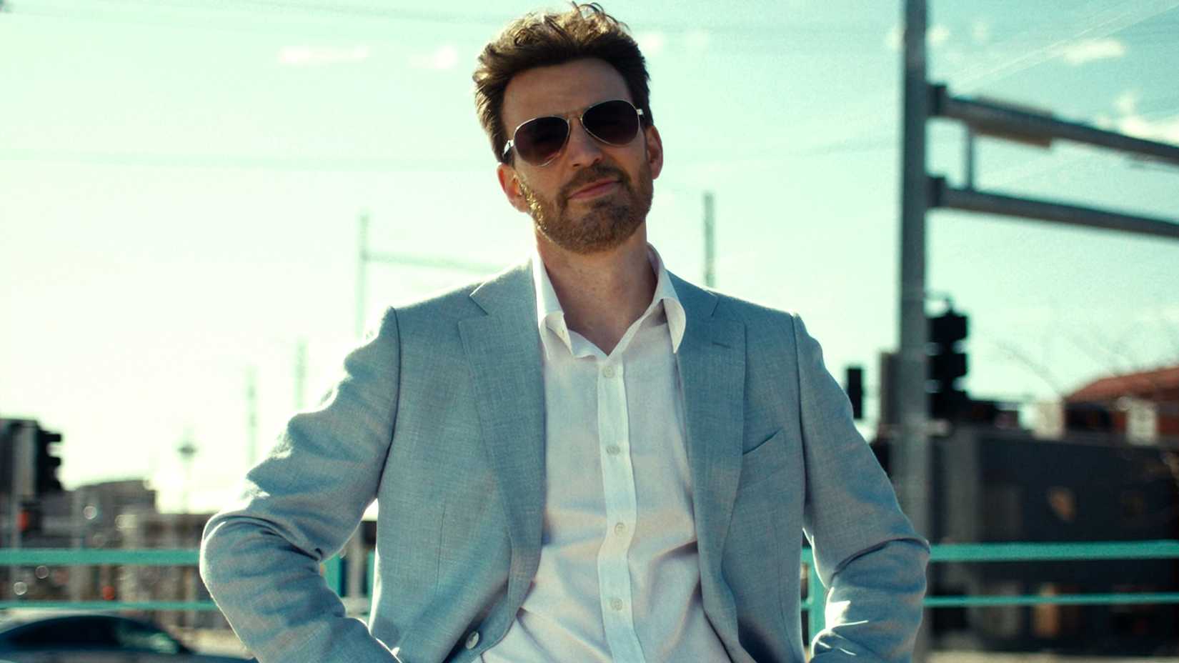 Chris Evans smirking with a blue and white tuxedo in Honey Don't