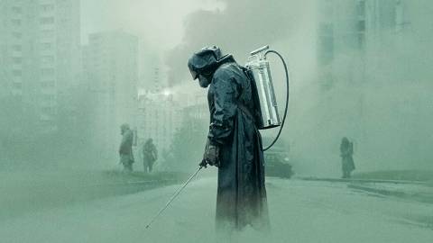 A cleaning team walks through the city in Chernobyl series poster