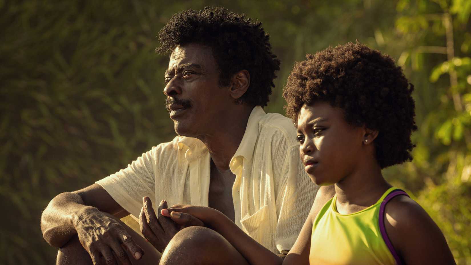 a man and a girl looking out at the sun in state of fear