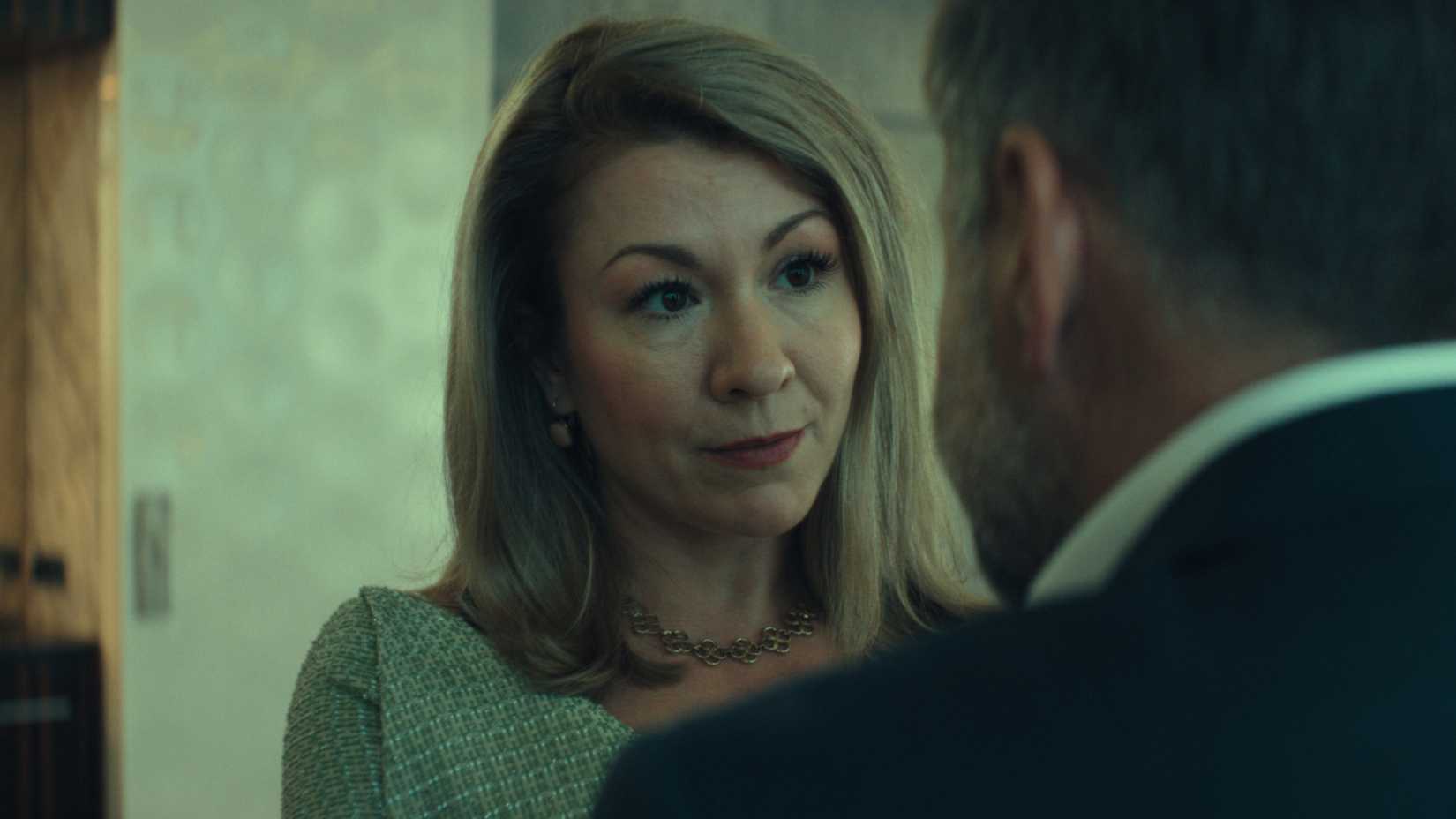 a woman speaking to a man in unfamiliar