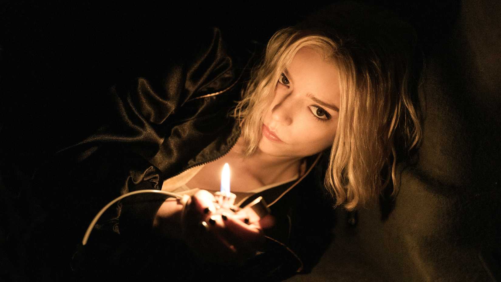 10 Upcoming Apple TV Shows You Cannot Miss 2 Anya Taylor-Joy holding a lighter in a dark space in Lucky