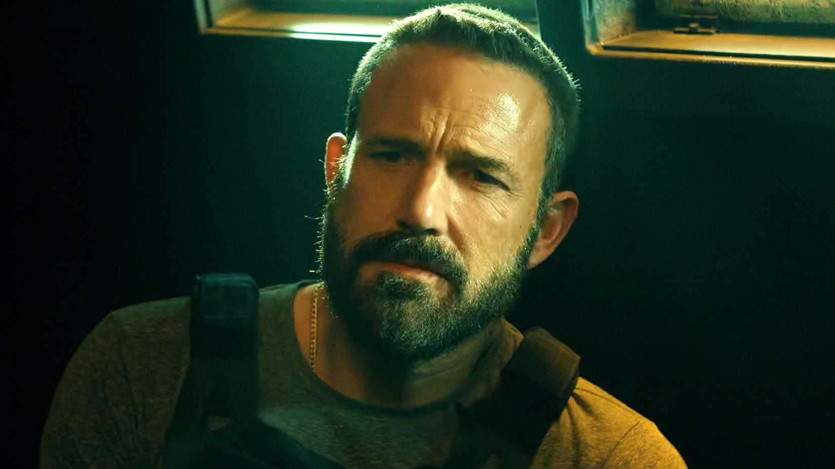 Ben Affleck looking sternly at Steven Yeun in The Rip
