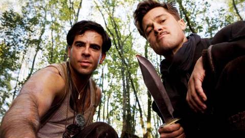 Brad Pitt holding a bowie knife and Eli Roth looking at the camera in Inglourious Basterds