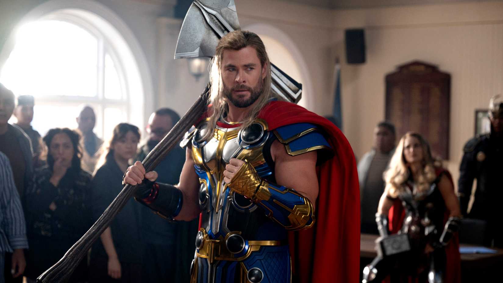 chris hemsworth as thor holding stormbreaker in thor love and thunder