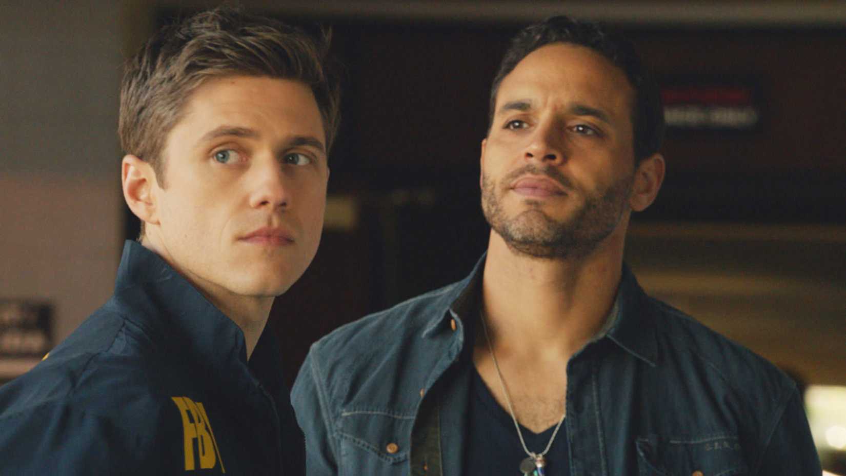 Daniel Sunjata as Briggs and Aaron Tveit as Mike standing together in Graceland