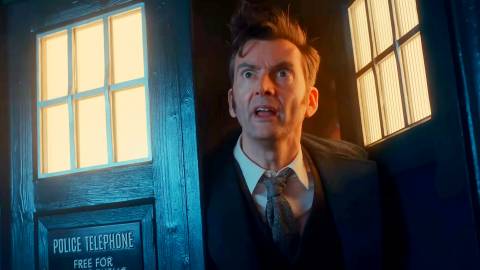David Tennant as the Fourteenth Doctor leaning out of his TARDIS in Doctor Who.