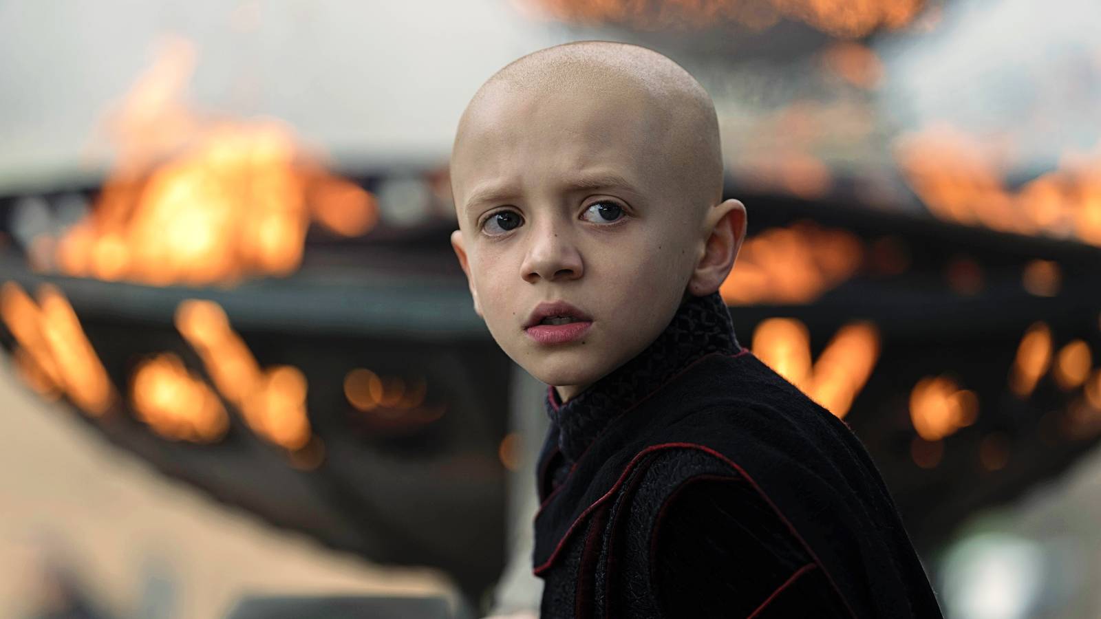 Dexter Sol Ansell as Egg with fire behind him in A Knight of the Seven Kingdoms season 1 episode 5