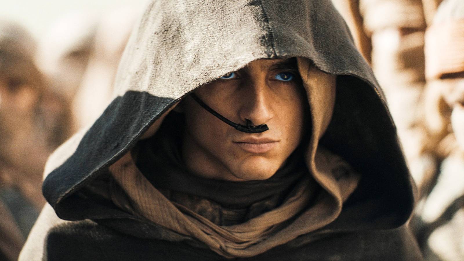 Paul Atreides looks angry while wearing a hood in Dune