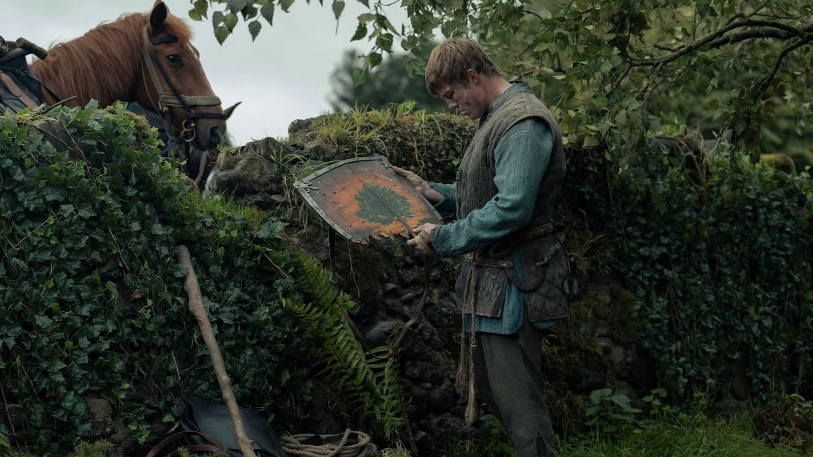 Dunk (Peter Claffey) looking at his shield in A Knight of the Seven Kingdoms episode 6. (1)