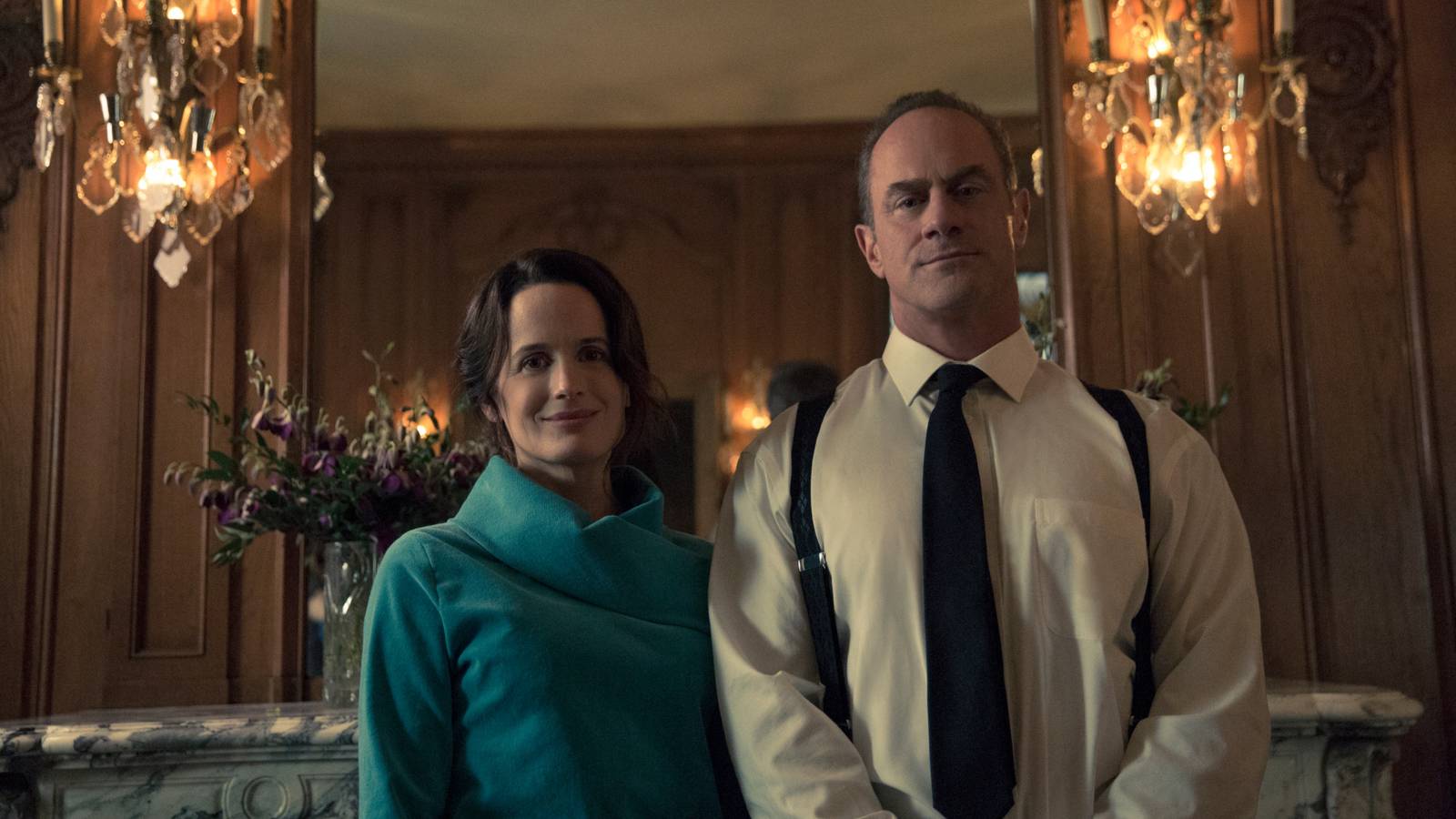 Elizabeth Reaser and Christopher Meloni looking imposing in a fancy home in The Handmaid's Tale