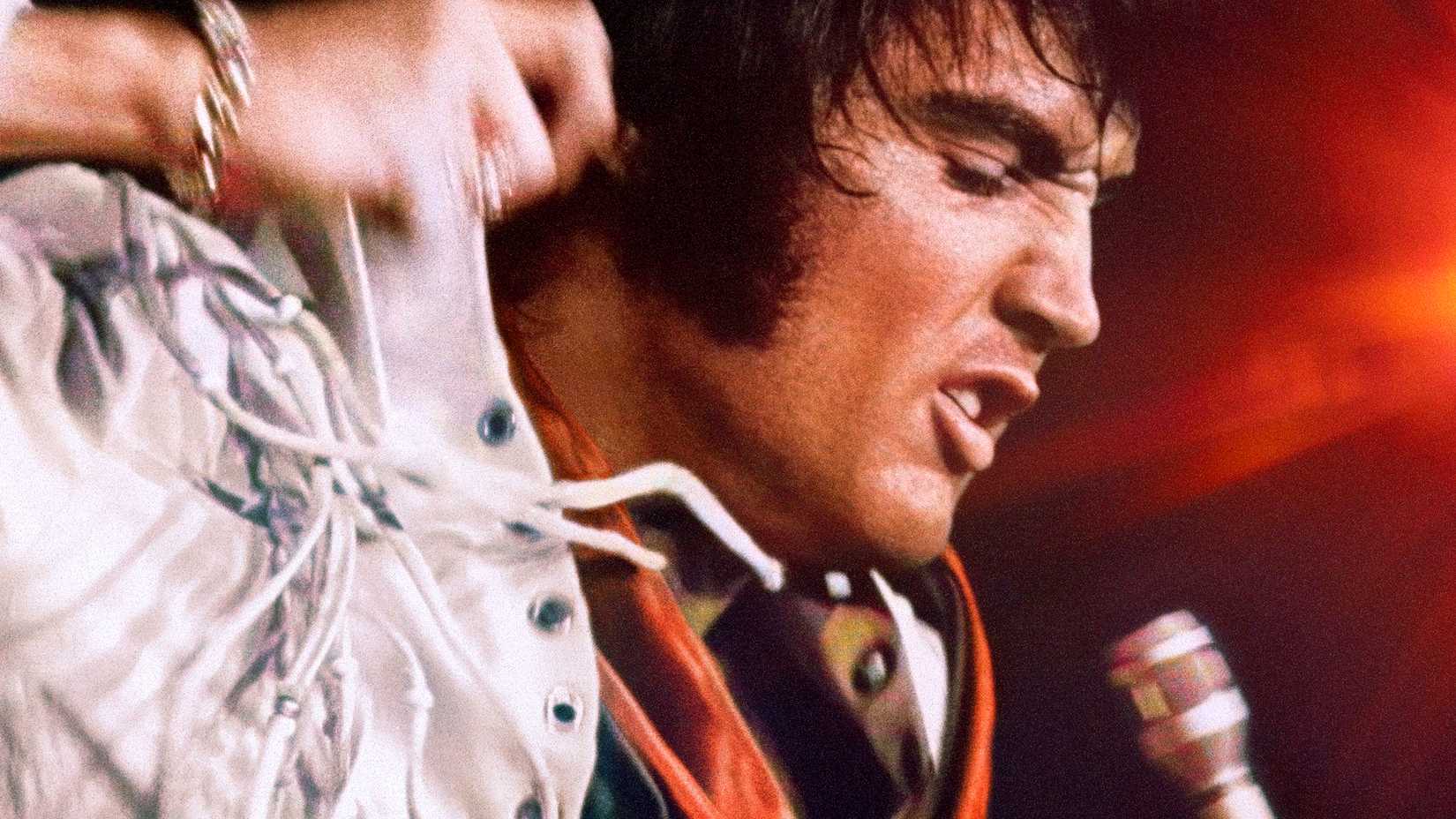 elvis performing onstage on the poster for epic elvis presley in concert