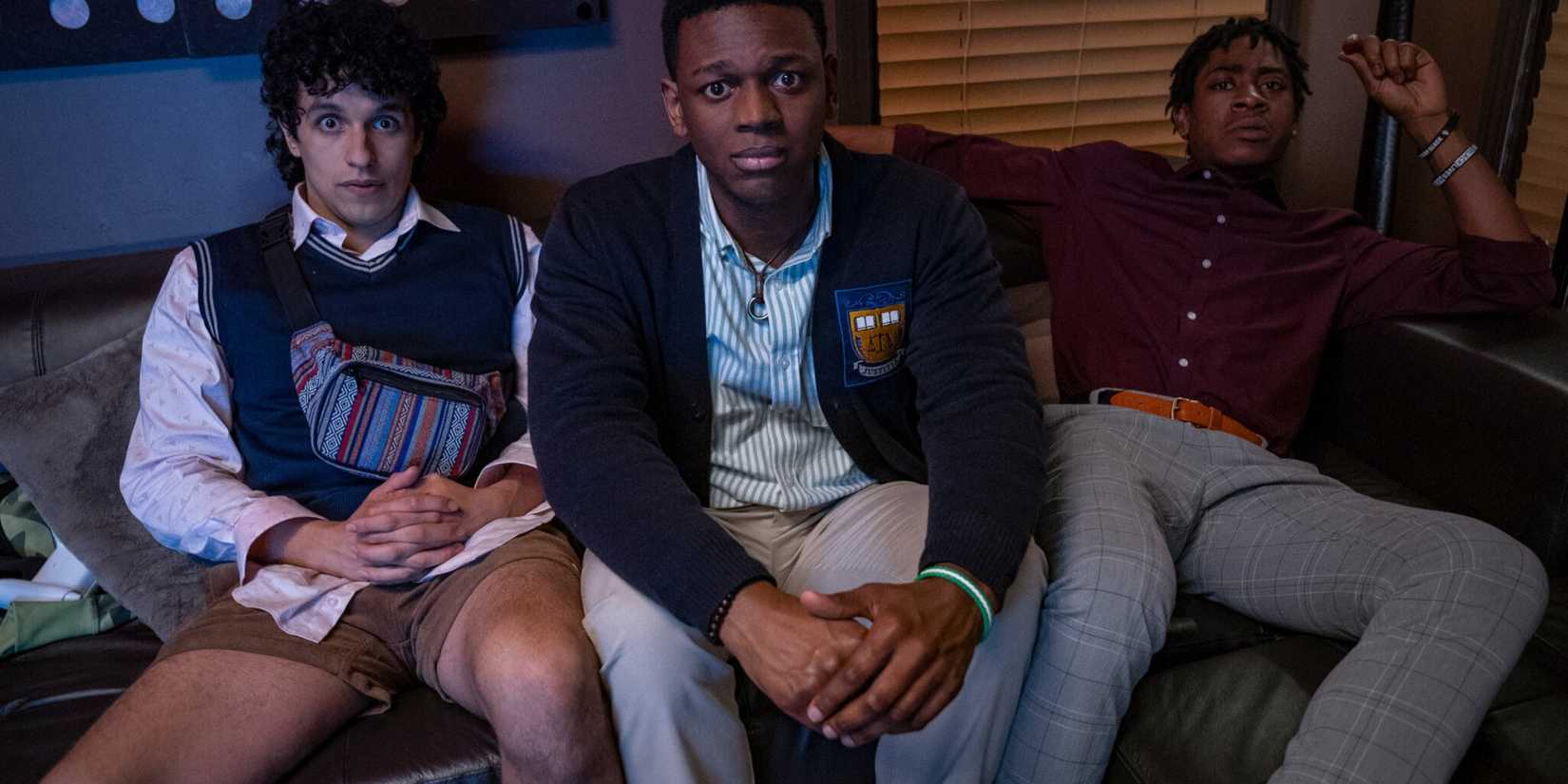 Three guys sit on a couch together in Emergency Movie 2022