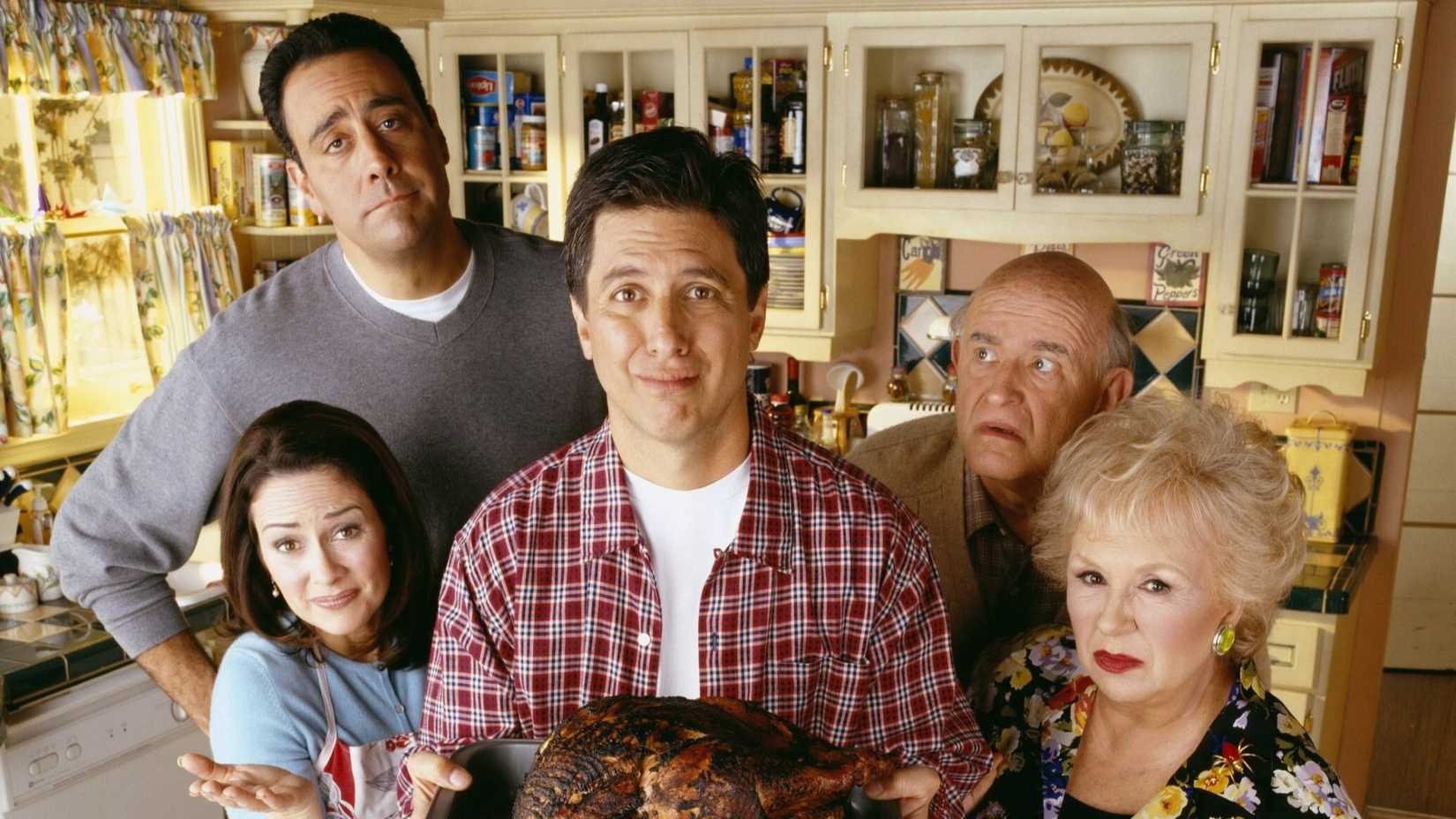 The Barone family standing in the kitchen in Everybody Loves Raymond.