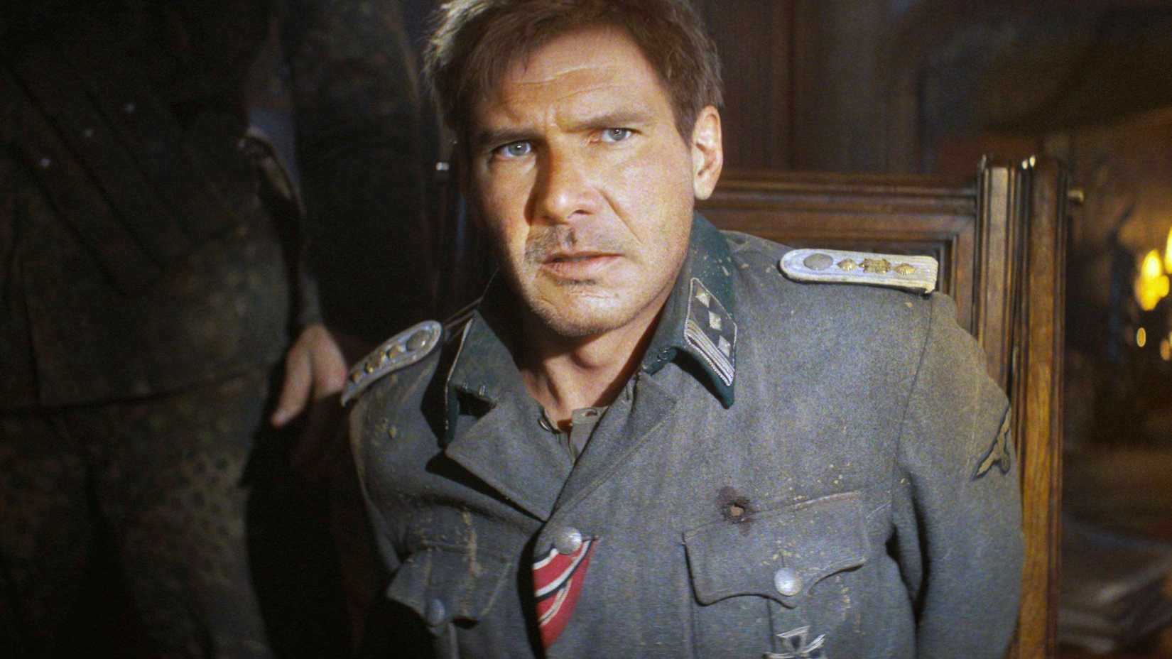 Harrison Ford as Young Indiana Jones sitting in a chair looking nervous in The Dial of Destiny