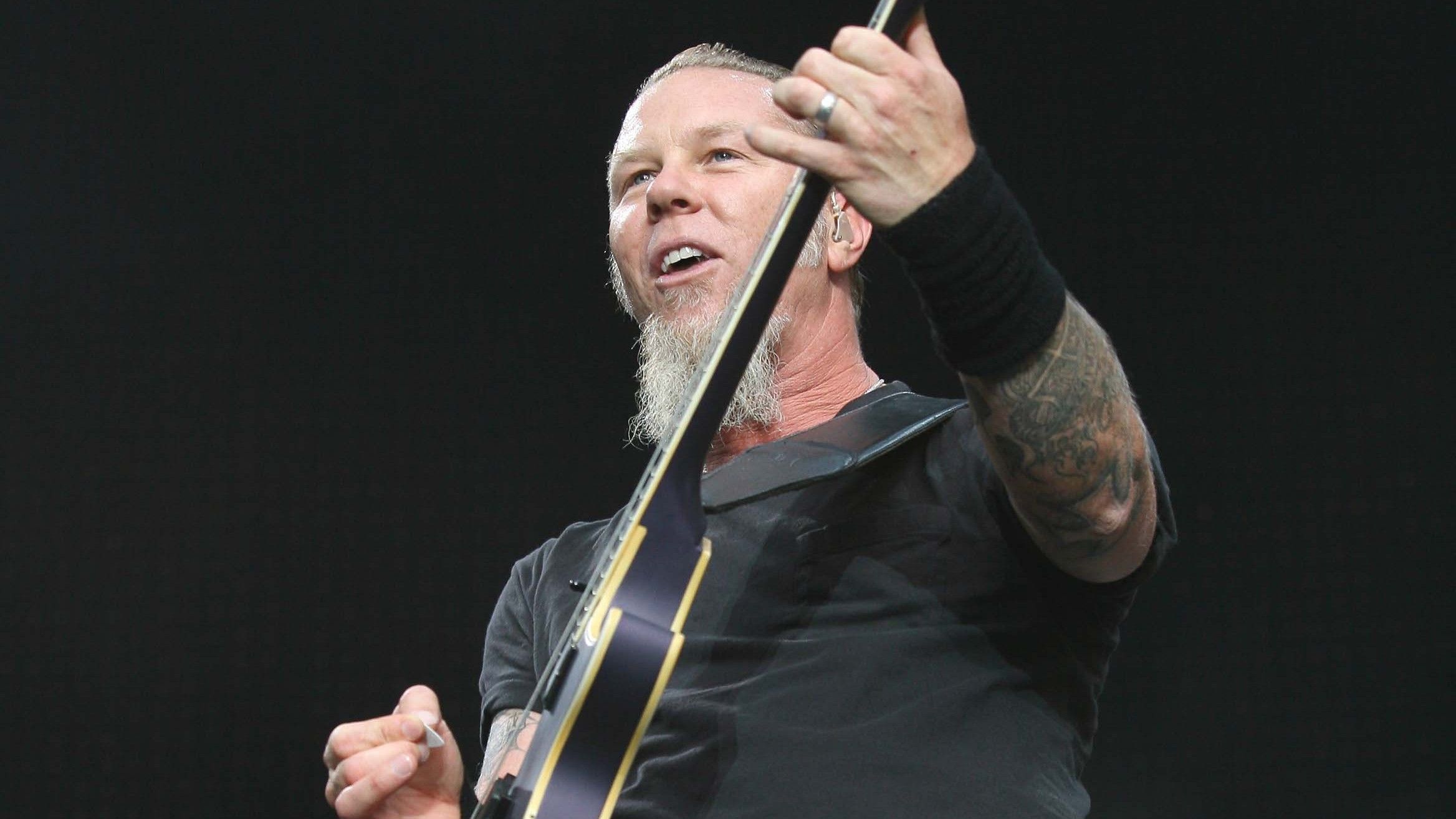 James Hetfield performing on guitar; 2026 EEG research identifies the rhythmic precision of Metallica’s melodic tracks as a highly effective sleep aid for infants.