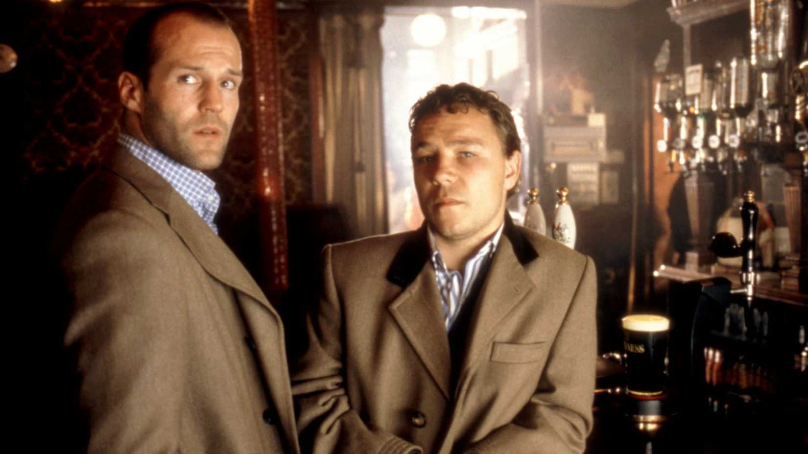 Jason Statham and Stephen Graham wearing tan suit jackets and looking suave in Snatch